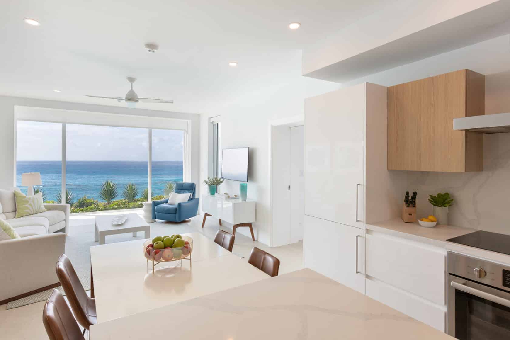 A living room with a view of the ocean, ideal for Bermuda vacation rentals.
