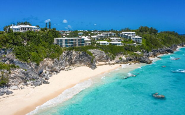 Aerial view of beach and cliffs in Bermuda, perfect for vacation rentals.