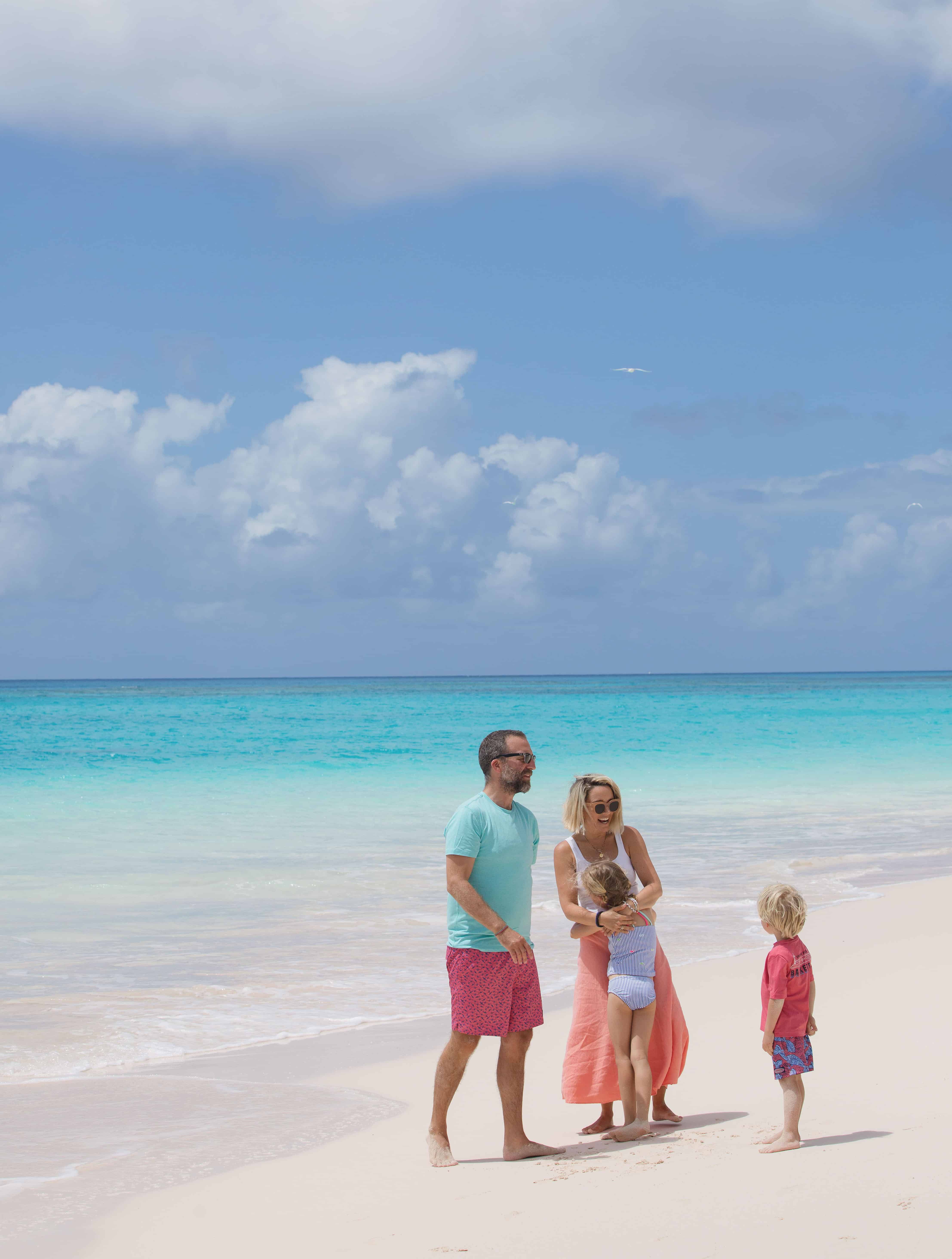 Family enjoying a day on the sunny Caribbean beach.