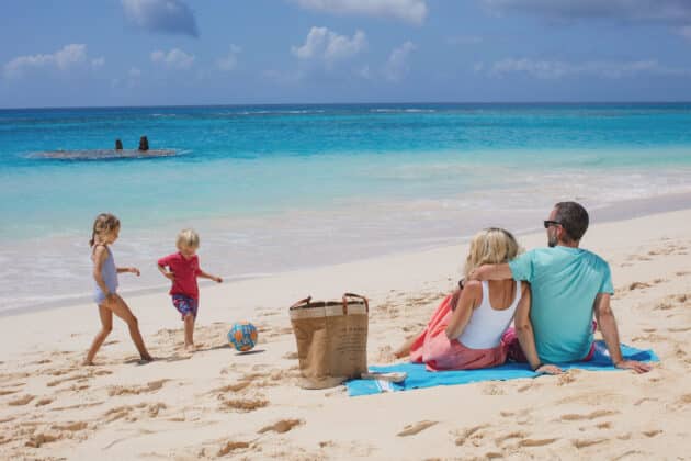 A group of people enjoying the sandy shores at a bermuda vacation rentals.