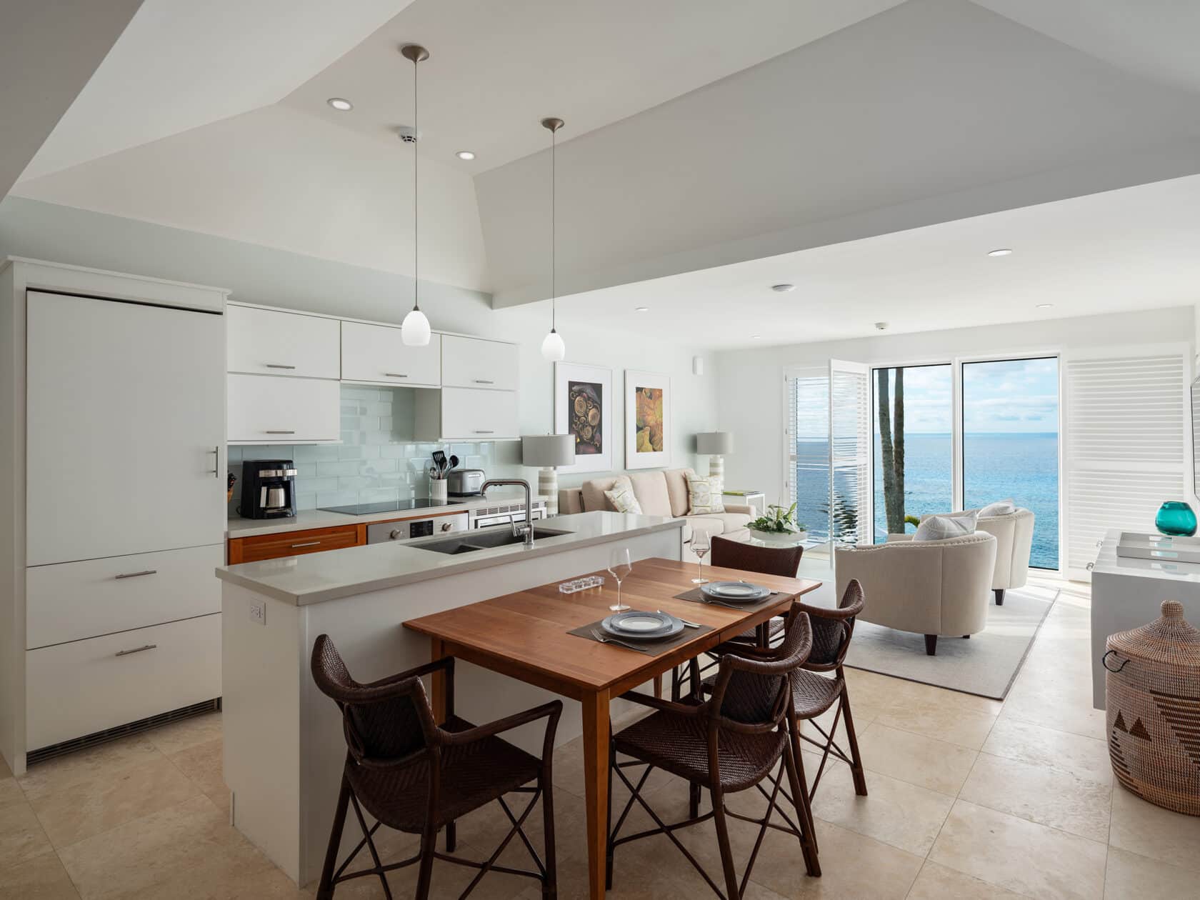 A kitchen and dining area with a view of the ocean, perfect for Bermuda vacation rentals.