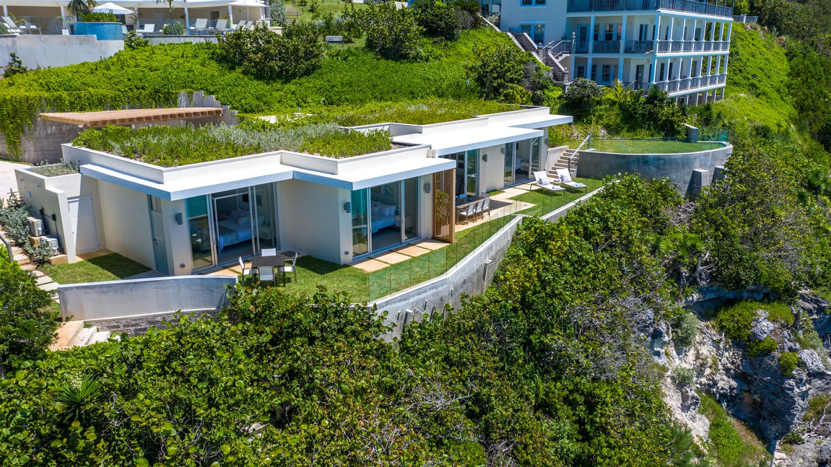 A house on a cliff overlooking the ocean in Bermuda.