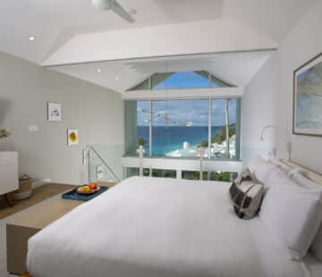 A bedroom with a view of the ocean, ideal for those seeking Bermuda vacation rentals.