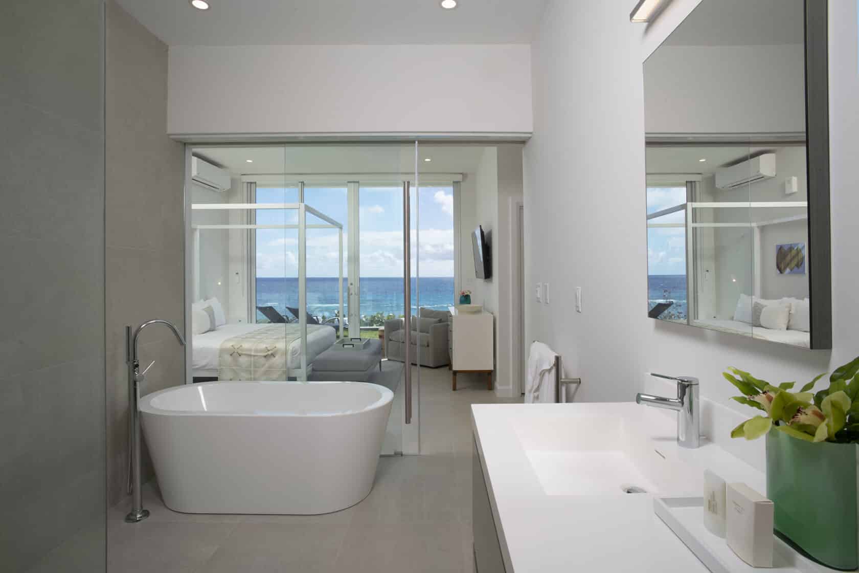 A modern bathroom with a tub and a view of the ocean in Bermuda.